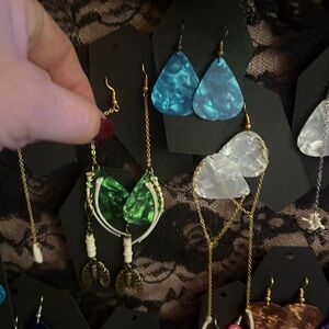 Hand made earrings, snake bones and guitar pics.
